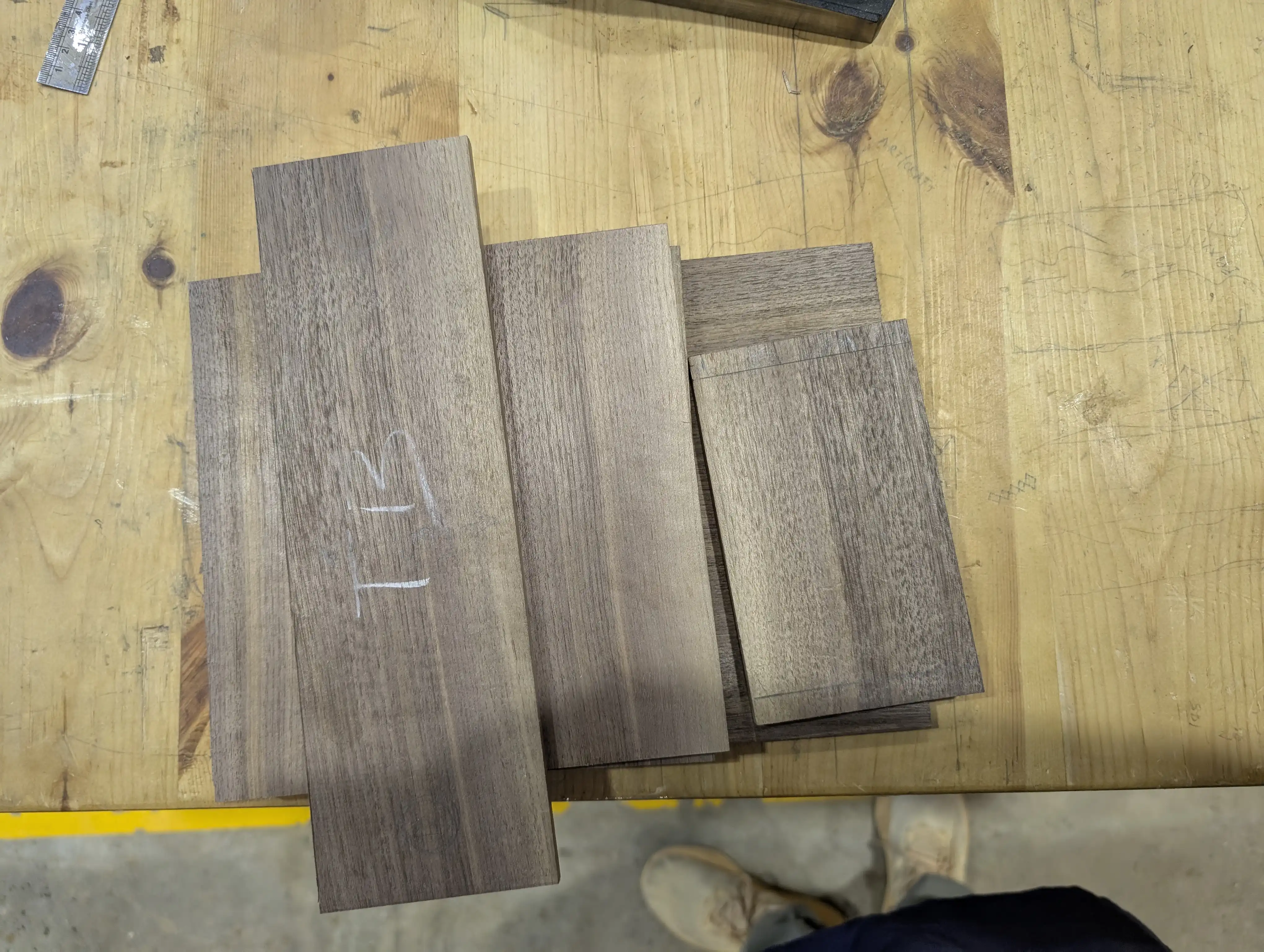 Cut walnut pieces on a workbench.