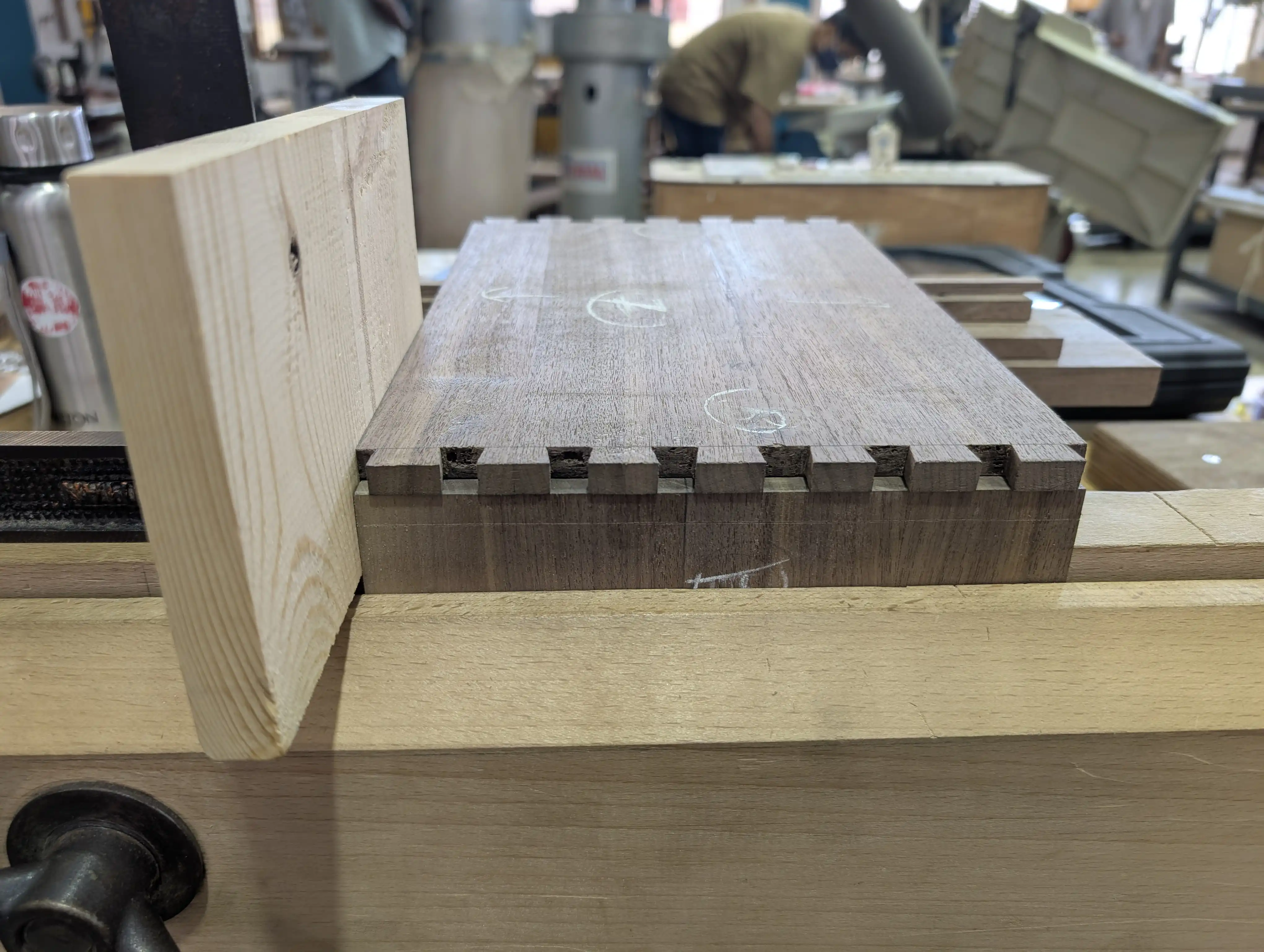 A walnut tail board sitting on top of another board for markings.